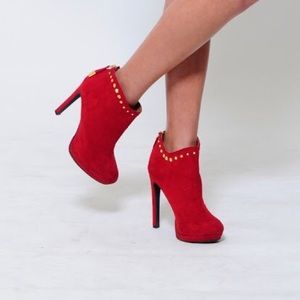 Red bootie heels with gold embellishments